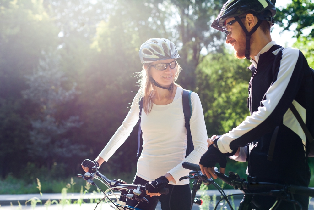 While you're visiting Harwich Port, take a ride on the Cape Cod Rail Trail. A couple standing by their bikes getting ready to ride.