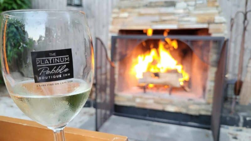 Wine by the outside fireplace at our Bed and Breakfast on Cape Cod