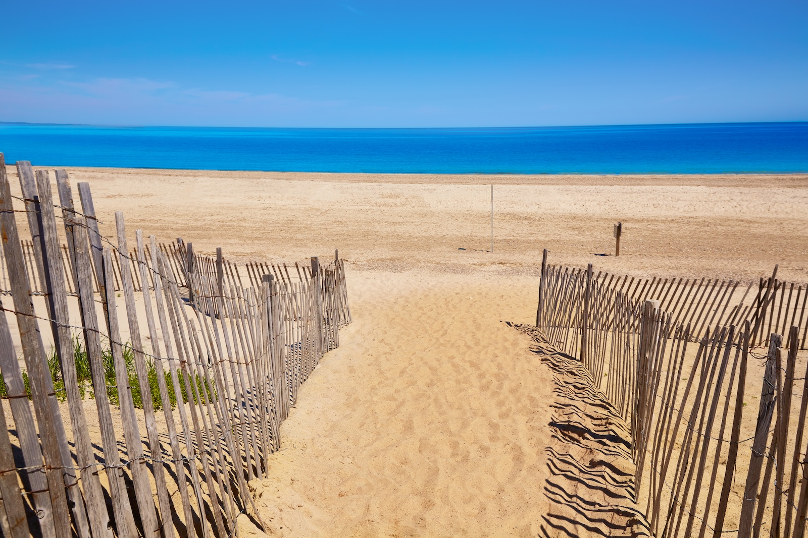 Sandy Neck Beach is one of many amazing Cape Cod beaches. This path with wooden fences leads the way to the bay.