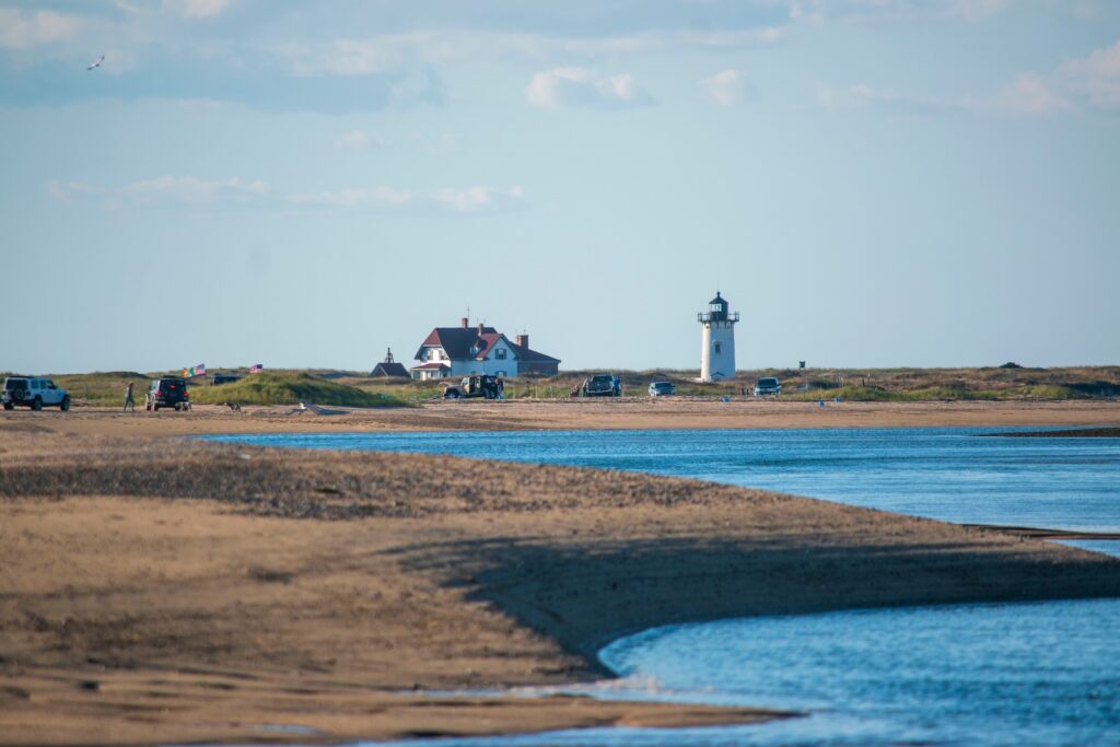The seashore with a house and a lighthouse on the Cape Code National Seashore.