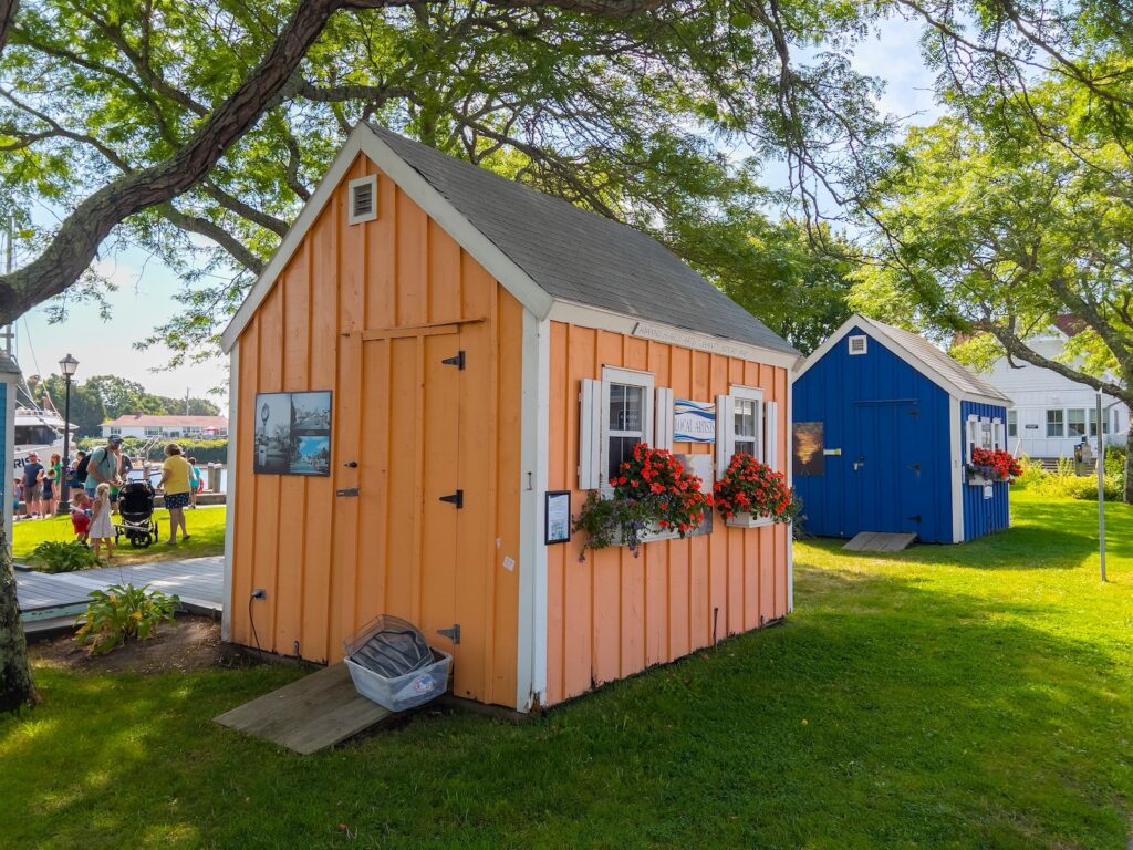An orange and blue building, artist Shanties at Bismore Park at Hyannis Port in town of Barnstable, Cape Cod, one of the unique things to do in Cape Cod in October.