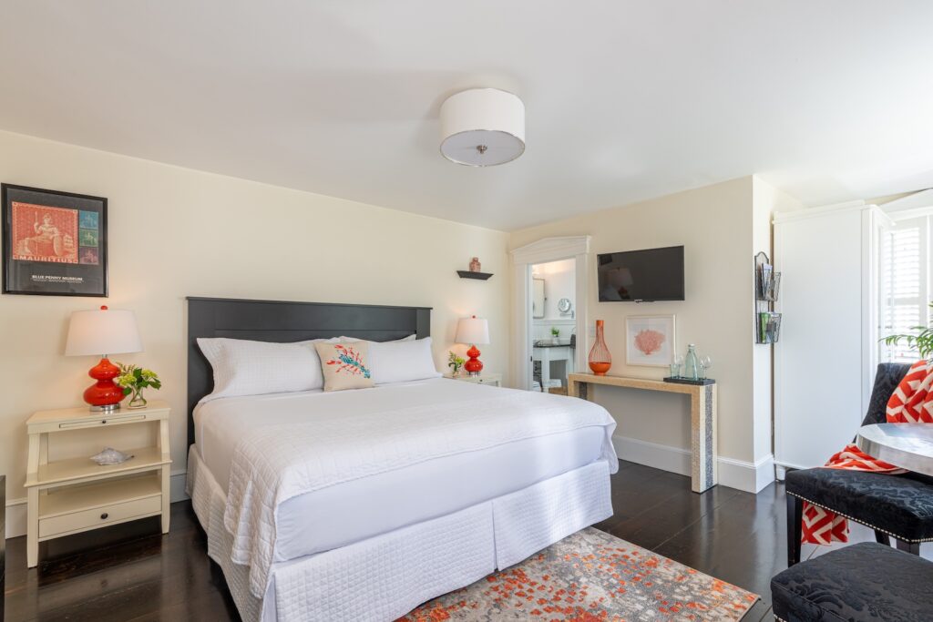 A luxury guest room featuring a king bed, television and seating area at the best Bed and Breakfast Cape Cod.