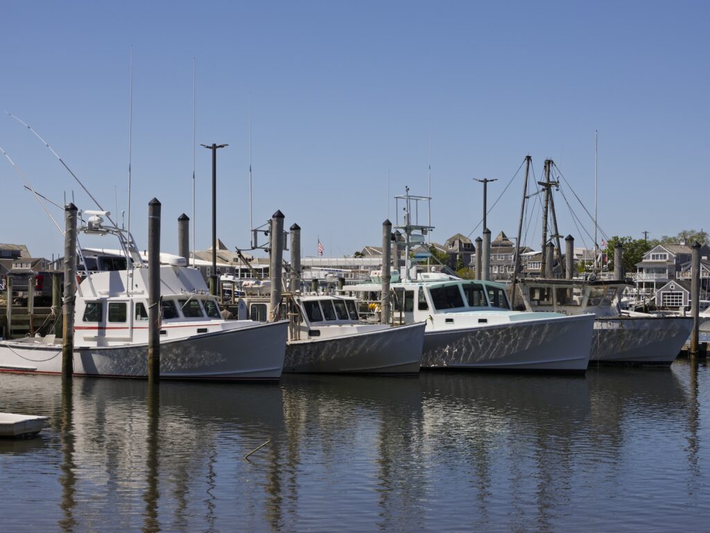 The Harwich port with boats on the water, perfect for a walk on a Cape Cod couples getaway.