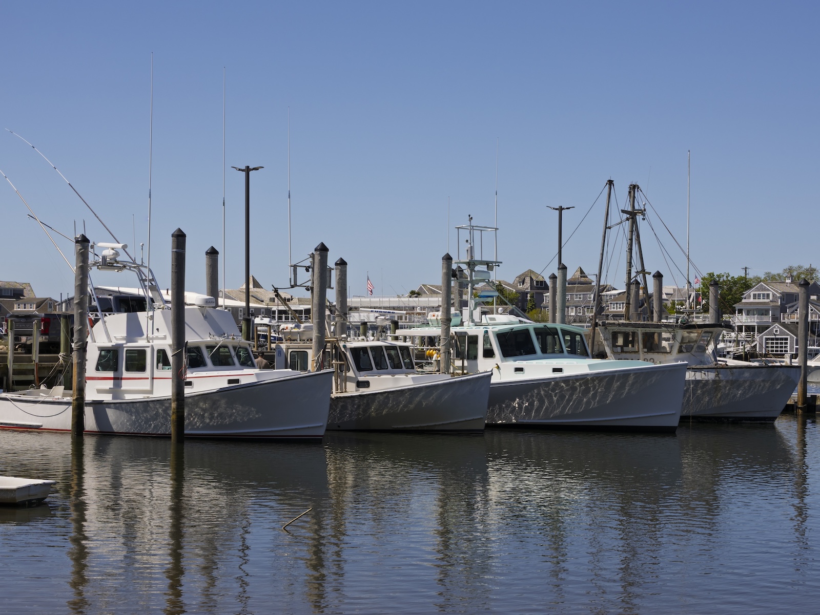 The Harwich port with boats on the water, perfect for a walk on a Cape Cod couples getaway.